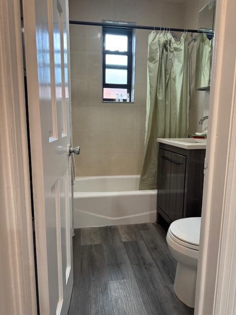 44-16 Macnish St Unit 5B, Elmhurst, NY 11373 - full bathroom featuring shower / bathtub combination with curtain, vanity, and wood finished floors