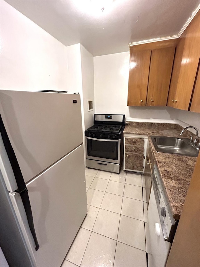 81-11 45th Ave Unit 3, Elmhurst, NY 11373 - kitchen featuring freestanding refrigerator, stainless steel gas range, brown cabinetry, dark countertops, and light tile patterned floors