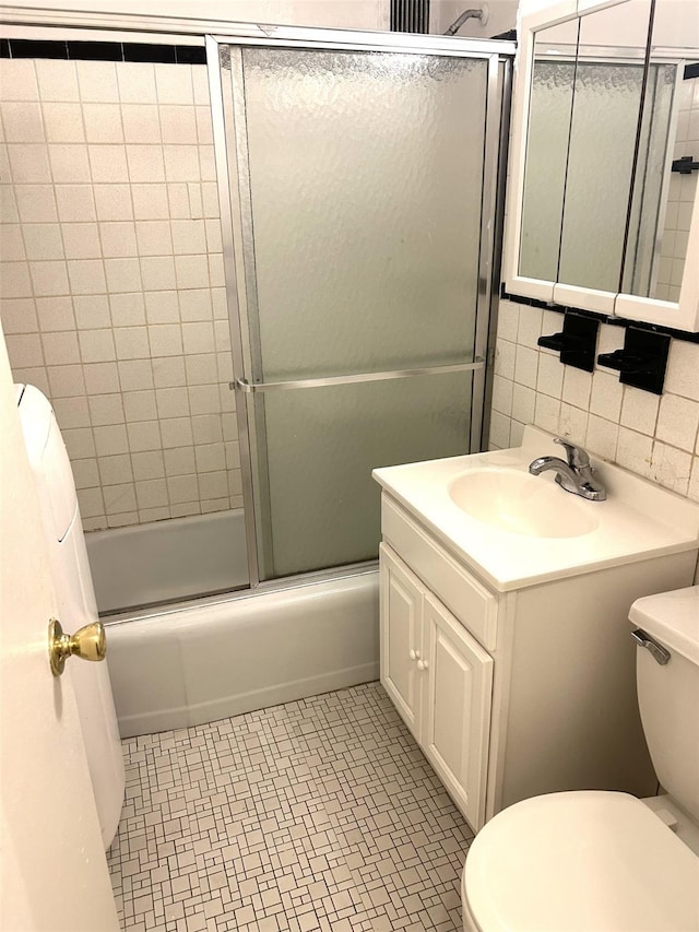 81-11 45th Ave Unit 3, Elmhurst, NY 11373 - full bathroom featuring vanity, bath / shower combo with glass door, and tile walls