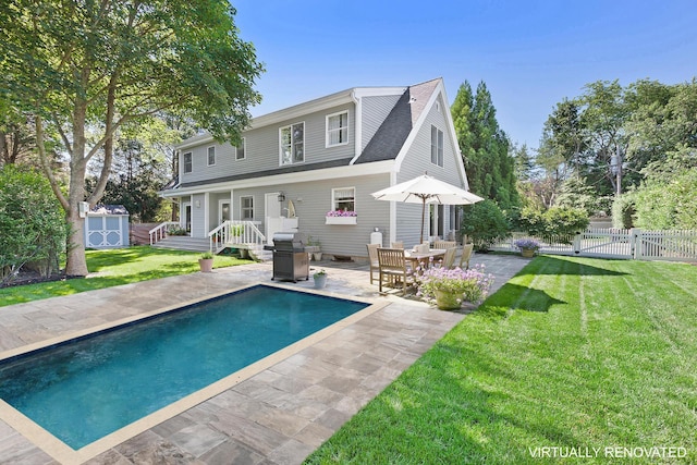 91 Howell St, Southampton, NY 11968 - back of property with a shed, a patio, and a shingled roof