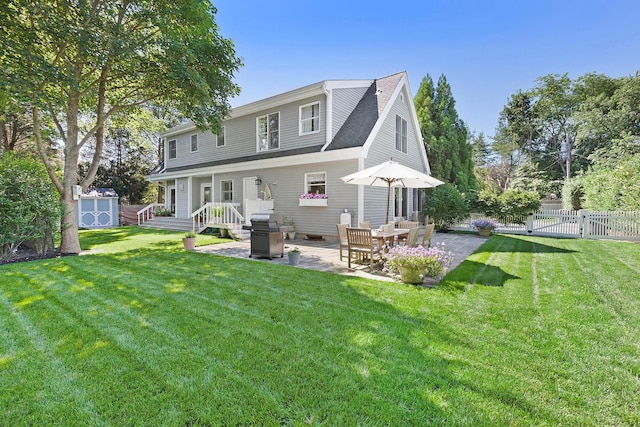 91 Howell St, Southampton, NY 11968 - rear view of property with a patio, a storage unit, and a shingled roof