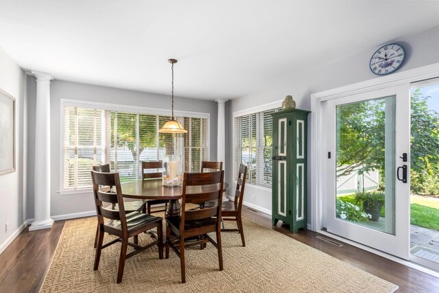 91 Howell St, Southampton, NY 11968 - dining space featuring decorative columns and wood finished floors