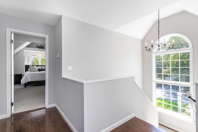 91 Howell St, Southampton, NY 11968 - corridor with an upstairs landing, a chandelier, dark wood finished floors, and lofted ceiling