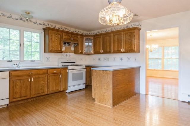 2 Demarest Rd, Chestnut Ridge, NY 10977 - kitchen featuring white appliances, a chandelier, light wood finished floors, and brown cabinetry