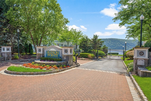402 Waterview Dr, Poughkeepsie, NY 12601 - view of asphalt road with street lighting, a gate, curbs, a mountain view, and a gated entry