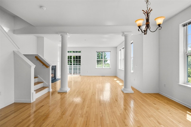 402 Waterview Dr, Poughkeepsie, NY 12601 - unfurnished living room featuring ornate columns, light wood finished floors, and stairs