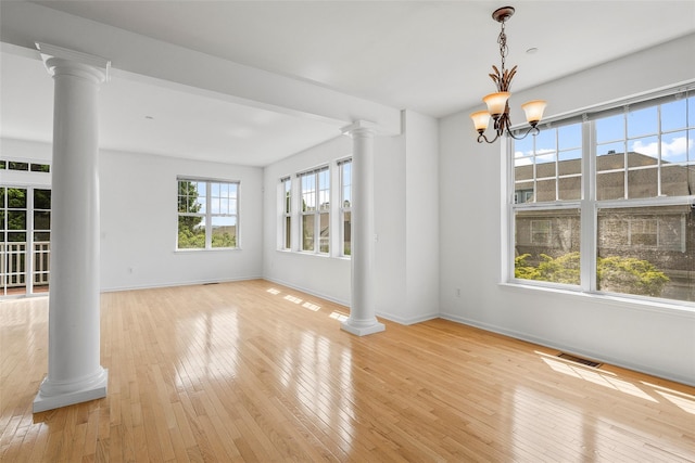 402 Waterview Dr, Poughkeepsie, NY 12601 - unfurnished room with ornate columns, hardwood / wood-style floors, and a chandelier