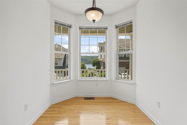 402 Waterview Dr, Poughkeepsie, NY 12601 - unfurnished dining area with light wood-type flooring and a water view