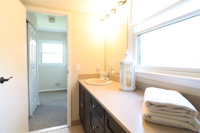 18 Hastings Ct Unit E, Yorktown Heights, NY 10598 - bathroom featuring double vanity and baseboards