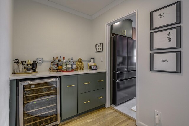 5 Birchwood Ct Unit 4N, Mineola, NY 11501 - indoor dry bar featuring freestanding refrigerator, wine cooler, light wood-style flooring, and ornamental molding