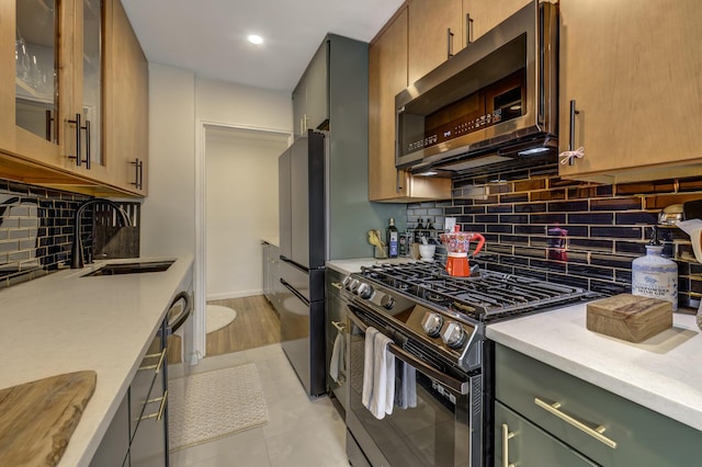 5 Birchwood Ct Unit 4N, Mineola, NY 11501 - kitchen with stainless steel appliances, tasteful backsplash, light stone counters, recessed lighting, and glass insert cabinets