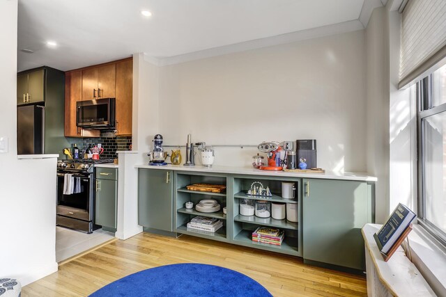 5 Birchwood Ct Unit 4N, Mineola, NY 11501 - kitchen featuring stainless steel appliances, light countertops, decorative backsplash, light wood-style flooring, and recessed lighting