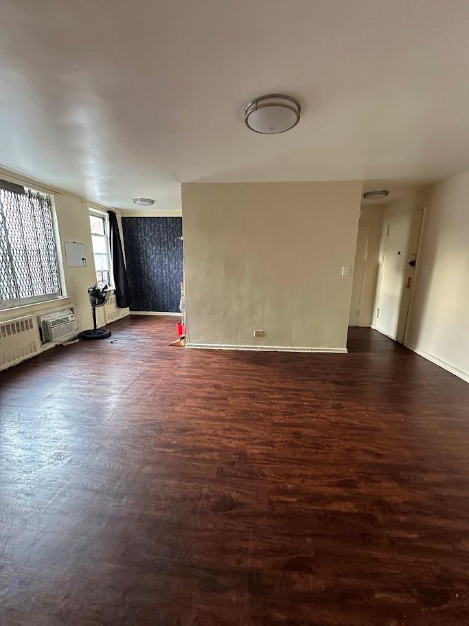 2385 Barker Ave Unit 6B, Bronx, NY 10467 - unfurnished room featuring dark wood-type flooring and a wall unit AC