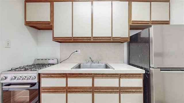 8420 153rd Ave Unit 6H, Howard Beach, NY 11414 - kitchen featuring freestanding refrigerator, gas range gas stove, light countertops, and white cabinets