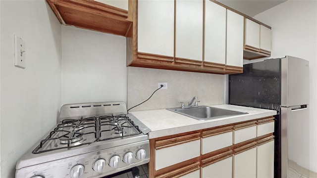 8420 153rd Ave Unit 6H, Howard Beach, NY 11414 - kitchen with stainless steel appliances, light countertops, and white cabinets