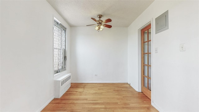 8420 153rd Ave Unit 6H, Howard Beach, NY 11414 - unfurnished room featuring radiator, ceiling fan, light wood-style flooring, and a textured ceiling