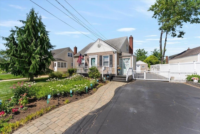 2 Croydon Dr, North Bellmore, NY 11710 - view of front of house featuring driveway and a gate