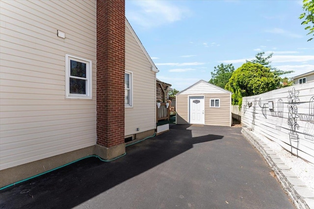 2 Croydon Dr, North Bellmore, NY 11710 - view of side of property with a storage unit and a chimney