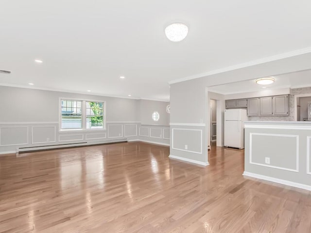 237 Brady Ave, Hawthorne, NY 10532 - unfurnished living room featuring a decorative wall, ornamental molding, a baseboard radiator, a wainscoted wall, and light wood-style flooring