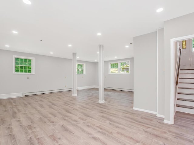 237 Brady Ave, Hawthorne, NY 10532 - below grade area featuring a baseboard heating unit, light wood finished floors, stairs, and recessed lighting