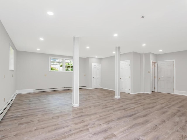 237 Brady Ave, Hawthorne, NY 10532 - below grade area featuring a baseboard radiator, light wood-style flooring, recessed lighting, and a baseboard heating unit