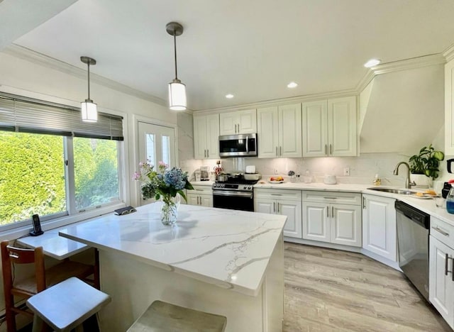 48 Marlene Dr, Syosset, NY 11791 - kitchen featuring stainless steel appliances, hanging light fixtures, light wood-style floors, white cabinets, and ornamental molding