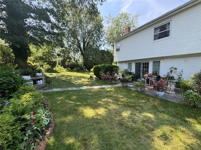 48 Marlene Dr, Syosset, NY 11791 - view of green lawn with a patio