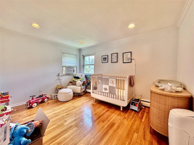 48 Marlene Dr, Syosset, NY 11791 - bedroom with crown molding, wood finished floors, a nursery area, a baseboard radiator, and recessed lighting