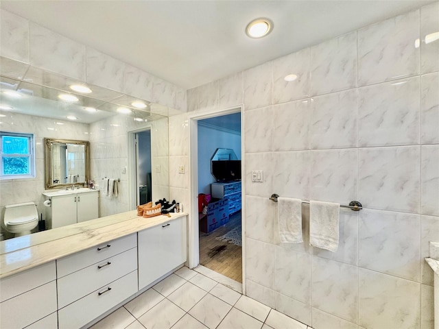 48 Marlene Dr, Syosset, NY 11791 - ensuite bathroom with tile walls, vanity, and tile patterned flooring