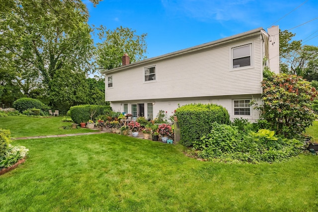 48 Marlene Dr, Syosset, NY 11791 - view of side of property with a chimney and a lawn