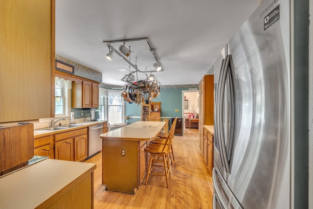 2 Gerri Ct, Wallkill, NY 12589 - kitchen with appliances with stainless steel finishes, a center island, light countertops, a chandelier, and a breakfast bar area