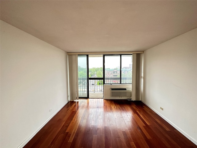 15038 Union Tpke Unit 3D, Kew Garden Hills, NY 11367 - empty room with dark wood-type flooring, a wall mounted air conditioner, and floor to ceiling windows