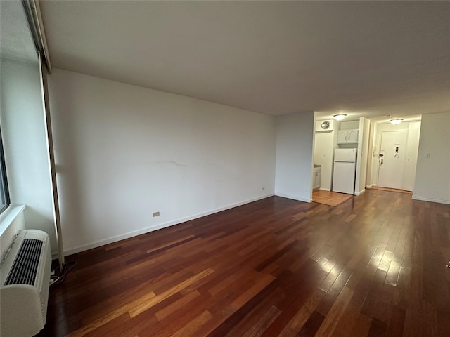 15038 Union Tpke Unit 3D, Kew Garden Hills, NY 11367 - unfurnished living room featuring dark wood finished floors and baseboards