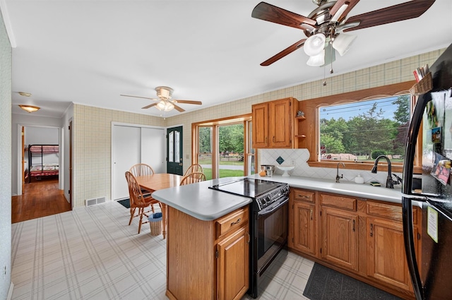 11 Seth Dr, New Hampton, NY 10958 - kitchen featuring black appliances, ceiling fan, light countertops, a peninsula, and wallpapered walls