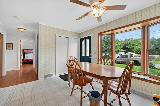11 Seth Dr, New Hampton, NY 10958 - dining space with healthy amount of natural light, wallpapered walls, a ceiling fan, ornamental molding, and light wood finished floors