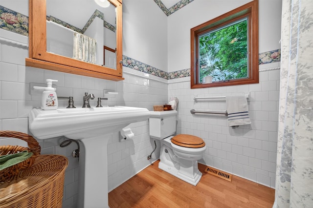 11 Seth Dr, New Hampton, NY 10958 - bathroom featuring tile walls, wood finished floors, wainscoting, and curtained shower