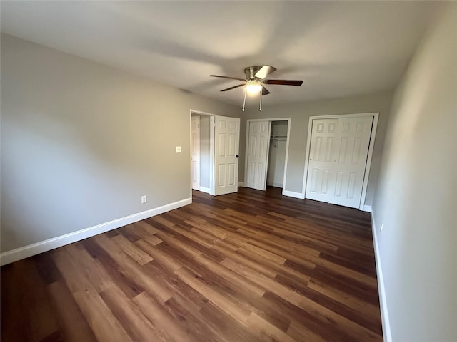 77 Adams Rd Unit 1D, Central Islip, NY 11722 - unfurnished bedroom featuring dark wood-style flooring, multiple closets, and a ceiling fan