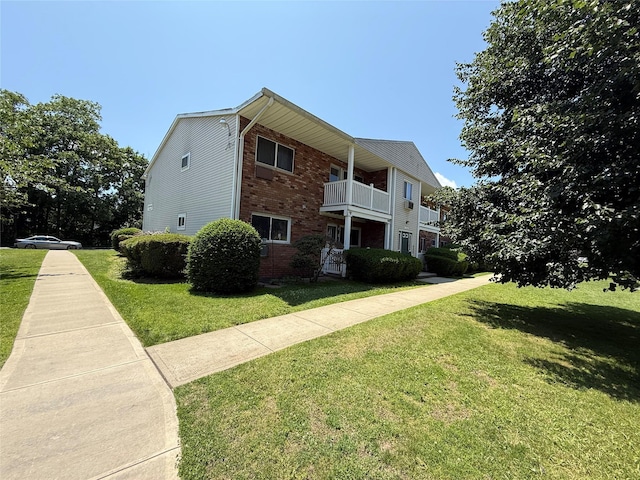 77 Adams Rd Unit 1D, Central Islip, NY 11722 - view of home's exterior featuring brick siding, a yard, and a balcony