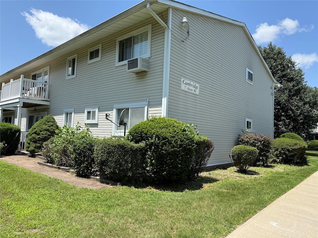 77 Adams Rd Unit 1D, Central Islip, NY 11722 - view of home's exterior featuring a lawn and a wall unit AC
