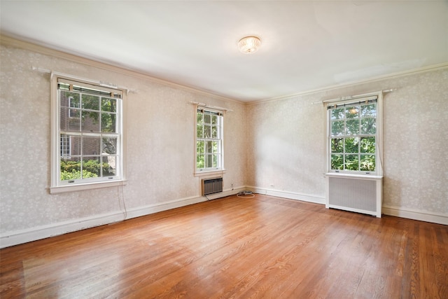 9 Bacon Ct, Bronxville, NY 10708 - unfurnished room featuring radiator heating unit, crown molding, wood finished floors, and wallpapered walls