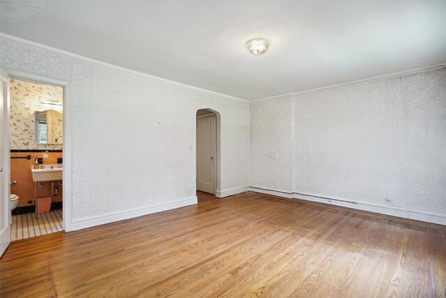 9 Bacon Ct, Bronxville, NY 10708 - spare room with arched walkways, wood finished floors, ornamental molding, and wallpapered walls