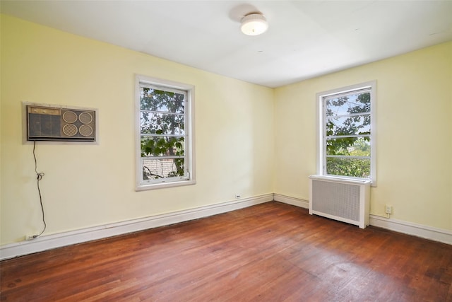 9 Bacon Ct, Bronxville, NY 10708 - spare room featuring radiator, wood finished floors, plenty of natural light, and an AC wall unit