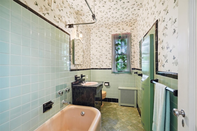9 Bacon Ct, Bronxville, NY 10708 - bathroom with wallpapered walls, tile walls, a tub to relax in, radiator heating unit, and a wainscoted wall
