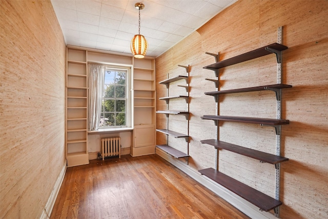 9 Bacon Ct, Bronxville, NY 10708 - spare room featuring radiator, wood finished floors, and built in shelves