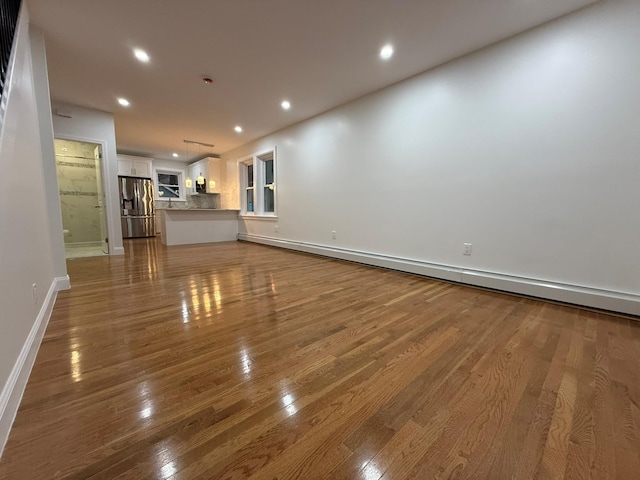 4223 Boyd Ave, Bronx, NY 10466 - unfurnished living room featuring wood finished floors, recessed lighting, and a baseboard radiator
