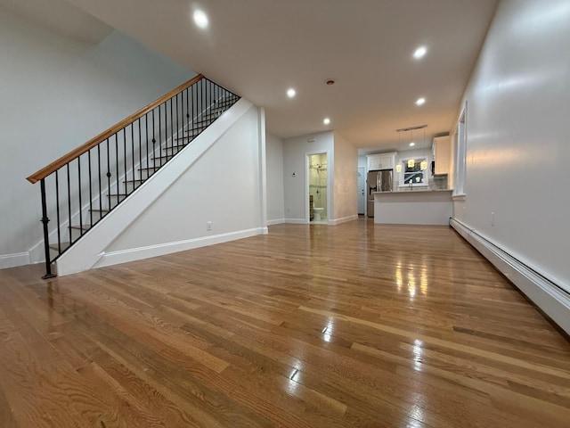 4223 Boyd Ave, Bronx, NY 10466 - unfurnished living room with light wood-type flooring, stairs, recessed lighting, and baseboard heating