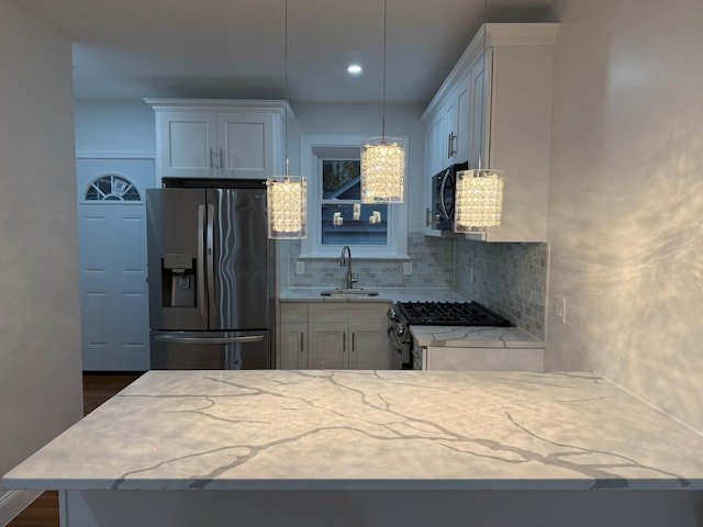 4223 Boyd Ave, Bronx, NY 10466 - kitchen featuring appliances with stainless steel finishes, backsplash, light stone counters, hanging light fixtures, and dark wood finished floors