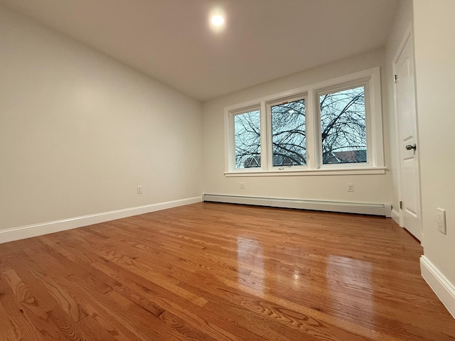 4223 Boyd Ave, Bronx, NY 10466 - spare room featuring a baseboard heating unit, light wood-style flooring, and lofted ceiling