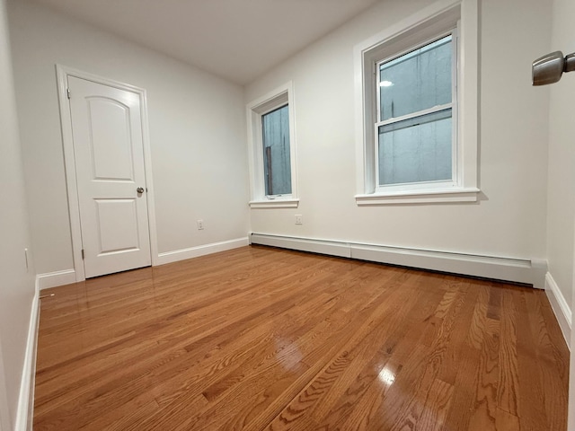 4223 Boyd Ave, Bronx, NY 10466 - spare room featuring a baseboard heating unit and wood finished floors