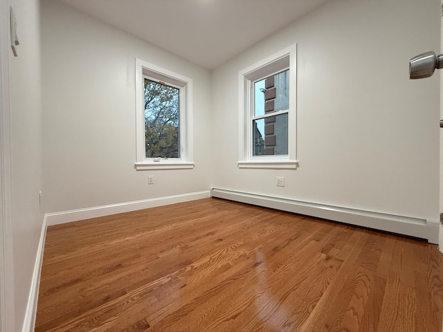 4223 Boyd Ave, Bronx, NY 10466 - empty room with baseboard heating and wood finished floors